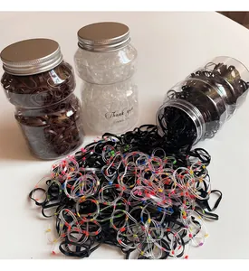 Detailed view of durable high-elastic hair bands stored in a clear jar with metal lid