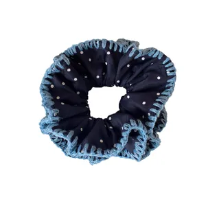 Navy blue polka dot scrunchie with light blue knitted edge for elegant hair styling
