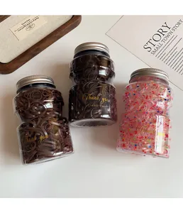 Detailed view of three jars with high elasticity hair ties in black, coffee, and pink colors
