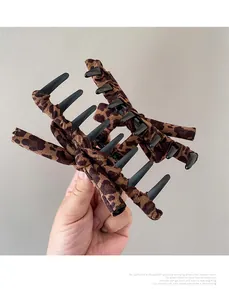 Detail shot of leopard print bow hair claw clip made of fabric and durable resin