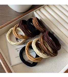 Macro shot of durable elastic woven hair ties in various neutral earthy colors