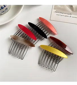 Detail showing various colors of minimalist acetate side hair combs with metal teeth