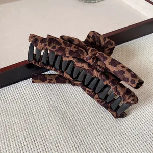 Large leopard print fabric bow hair claw clip for elegant women styling and long hair accessory
