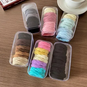 Kids high elasticity hair ties set in colorful boxes on wooden background