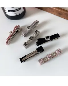 Detail of luxury hair clip set featuring velvet bow and colorful crystal rhinestones