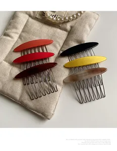 Detail of 6-piece acetate hair combs set with metal teeth on a quilted fabric mat