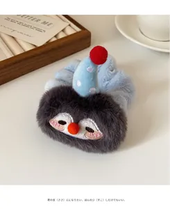 Detail of plush cartoon penguin scrunchie featuring soft blue fabric and cute embroidery