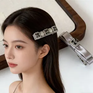 Elegant bow hair clip set with grey satin and shimmering crystals for women
