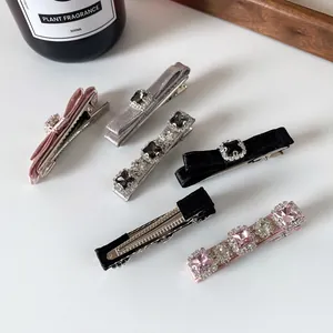 Elegant bow hair clips set with shimmering rhinestones and velvet texture for women