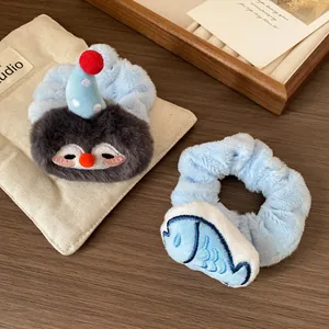 Cute plush penguin and fish scrunchies for winter hairstyles with soft velvet texture