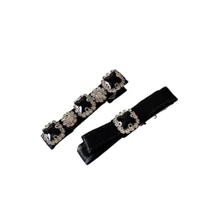 Elegant black bow hair clip set with sparkling rhinestones and square gemstones