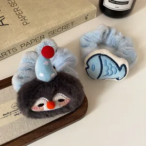 Cute plush penguin and fish scrunchies set in blue and grey for autumn hairstyles