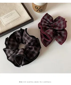 Detail shot of red and grey plaid scrunchies with premium fabric texture and stitching