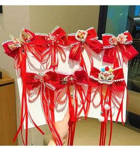 Detail of red velvet bow hair clip with traditional Chinese embroidery and long tassels