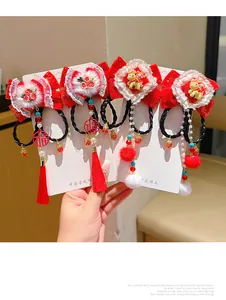Detail of Chinese New Year hair clips with red bows, tassels and festive charms