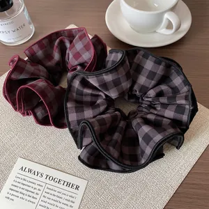 Two-pack of vintage plaid scrunchies in red and black grey with elegant textures
