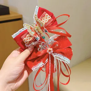 Traditional red velvet hair bow with pearl tassels and butterfly charm for girls
