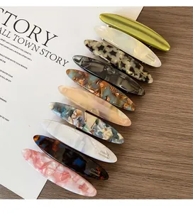 Close-up of nine handmade acetate hair clips featuring tortoiseshell and marble patterns