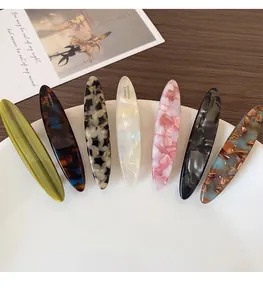 Set of seven acetate spring hair clips in various shell and tortoiseshell patterns