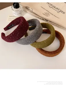 Detail of four handmade sequined tweed headbands in red, grey, green, and caramel tones
