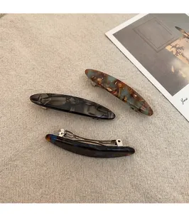Detail of French handmade acetate hair clips in marble and tortoiseshell patterns