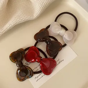 Chic bow hair ties set with heart-shaped resin elements in four elegant colors