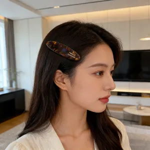 French handmade acetate hair clip with tortoise shell pattern on a model side view