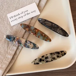 Set of four handmade acetate spring hair clips in retro tortoiseshell and marble patterns