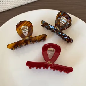 Three minimalist acetate claw clips in tortoiseshell and burgundy with France Handmade print