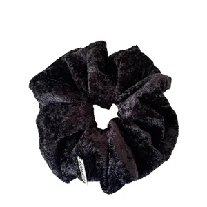 Minimalist black velvet large scrunchie with soft pleated texture and woven label