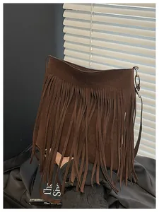 Detail of bohemian dark brown suede shoulder bag featuring long fringe and silver hardware