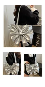 Close-up of metallic silver tote bag featuring a large decorative bow and shiny texture