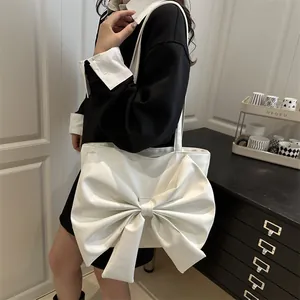 Chic white PU leather tote bag with large bow decoration for women commuting and daily wear