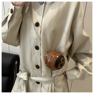 Close-up of a brown patent leather billiard ball shaped crossbody bag with number 8 print