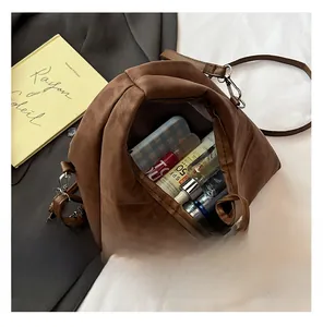 Interior storage capacity of the minimalist brown matte crossbody bag with personal items
