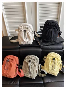 Detailed view of lightweight nylon drawstring crossbody bags in five stylish colors