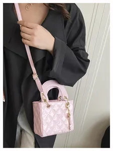 Pink quilted patent leather mini handbag styled with a black coat for an elegant look