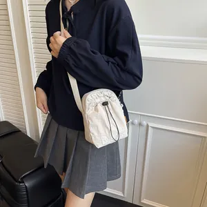 Japanese style beige nylon drawstring crossbody bag with adjustable strap for women