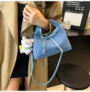 Blue leopard print suede handbag with cute plush rabbit charm and delicate bow detail