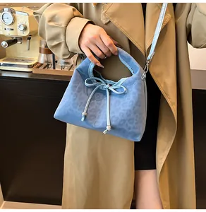 Light blue faux suede dumpling bag with leopard print and drawstring bow detail