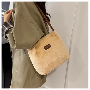 Detail of plush beige tote bag featuring fuzzy texture and fashion bag leather patch