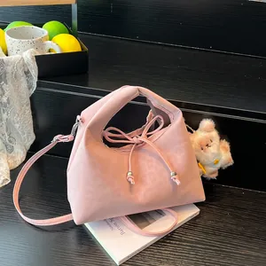 Pink drawstring dumpling shoulder bag with leopard pattern and white plush bear charm