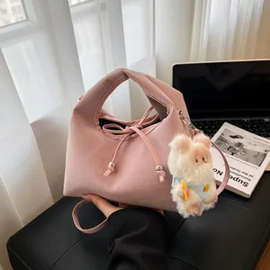 Pink crossbody dumpling bag with drawstring and cute plush sheep pendant for women