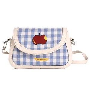 Blue and white plaid saddle bag with red apple motif and cream leather trim