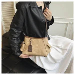 Detail of retro bucket bag with color-contrast stitching and fashion tag on side