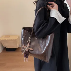 Retro dark brown oil wax leather tote bag with a cute plush rabbit charm for women