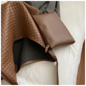 Close-up of brown woven tote bag showing detailed texture and matching pouch