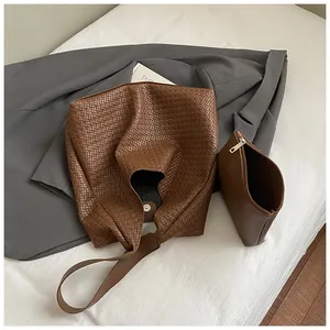 Detailed view of brown woven leather tote bag set including matching small zipper pouch