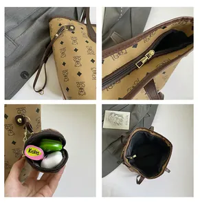 Detail view of khaki tote bag zipper, hardware hooks, and small accessory pouch