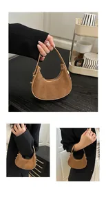 Detail of tan faux suede half moon handbag featuring smooth leather trim and gold hardware